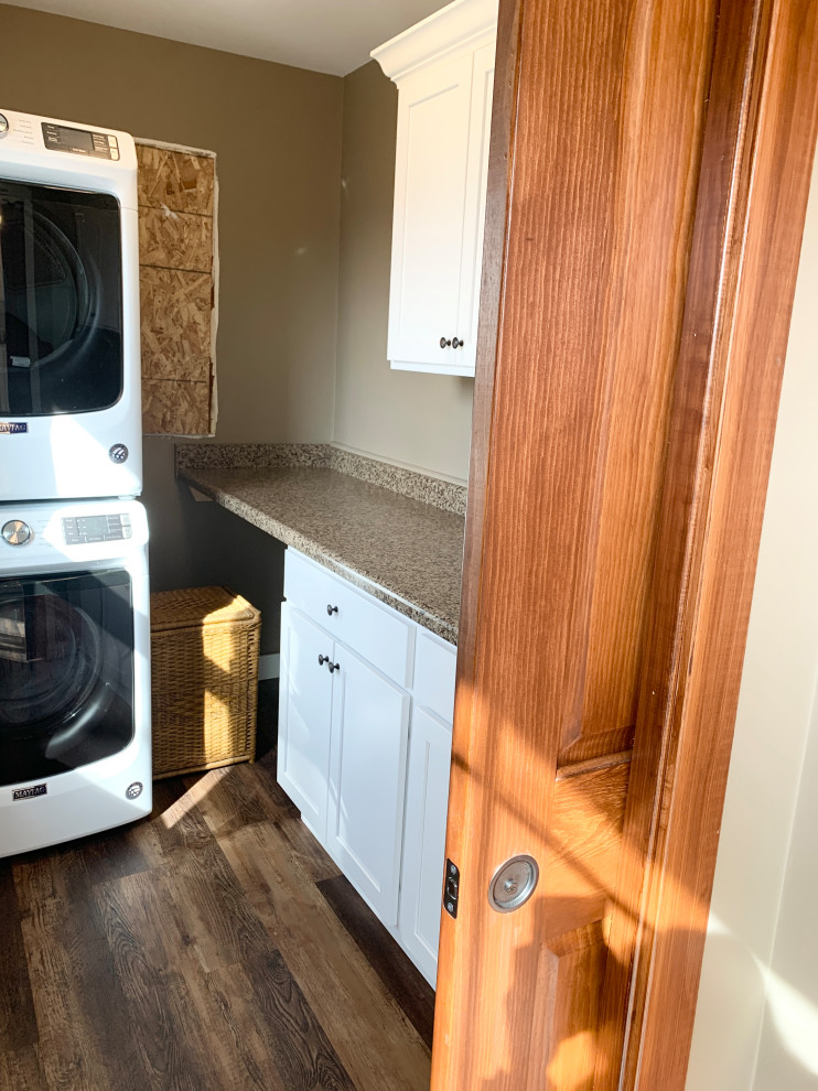 Mid-sized country galley laundry room in Other with a farmhouse sink, flat-panel cabinets, beige cabinets, quartz benchtops, beige splashback, ceramic splashback, medium hardwood floors, brown floor and multi-coloured benchtop.