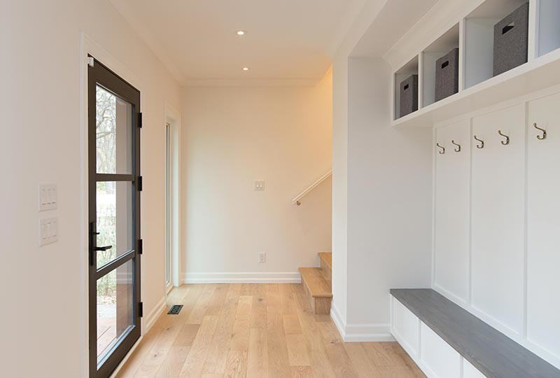 Inspiration for a transitional light wood floor single front door remodel with white walls and a black front door