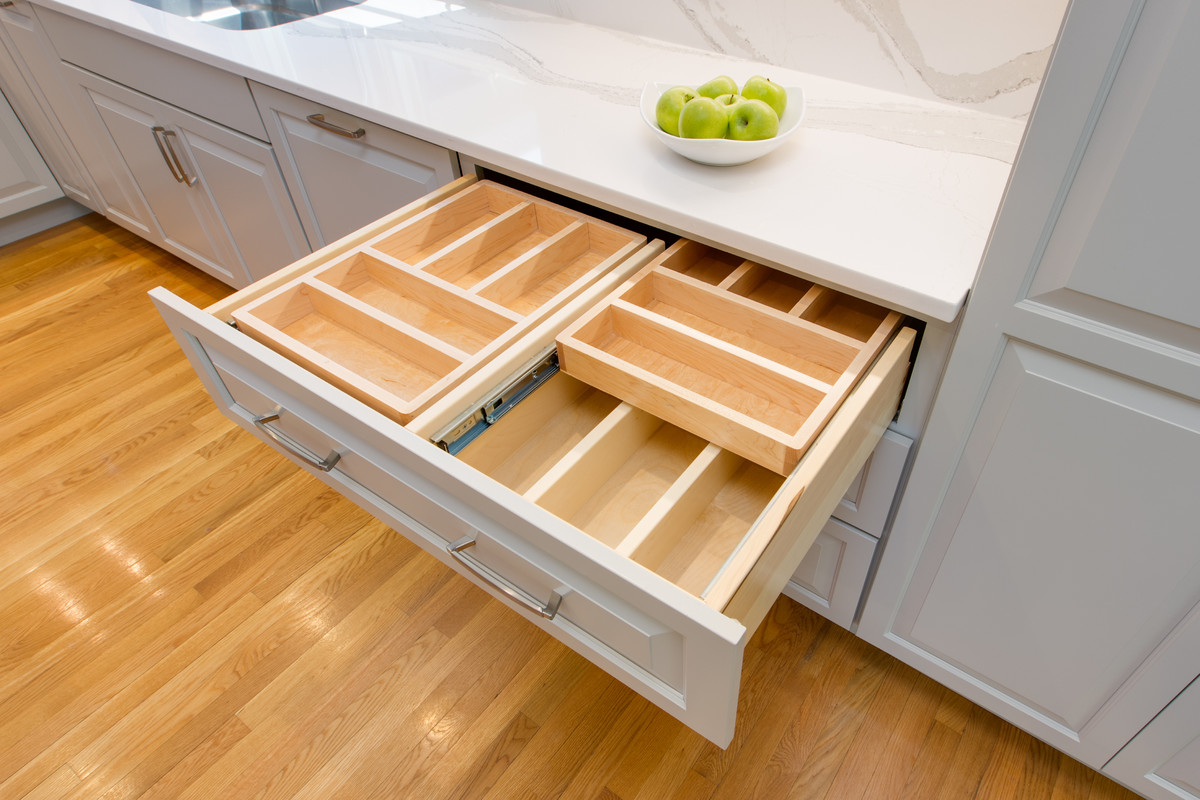 Large transitional l-shaped medium tone wood floor open concept kitchen photo in Boston with an undermount sink, raised-panel cabinets, gray cabinets, quartz countertops, stone slab backsplash, paneled appliances and an island