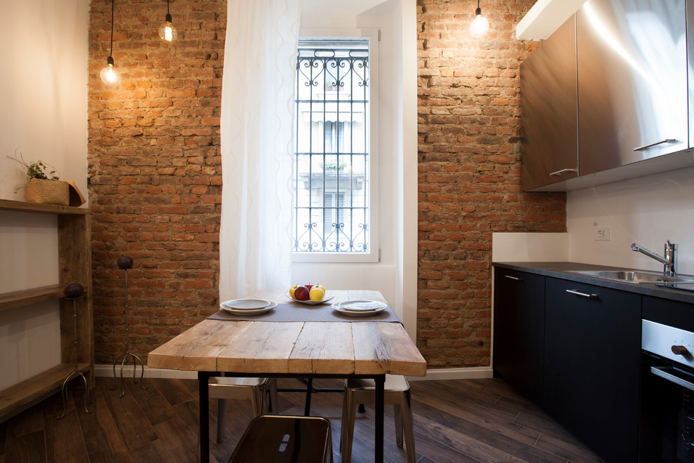 This is an example of a mid-sized industrial open plan dining in Milan with white walls, porcelain floors and brown floor.