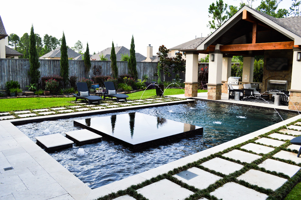 Example of a large classic backyard stone and custom-shaped pool house design in Houston