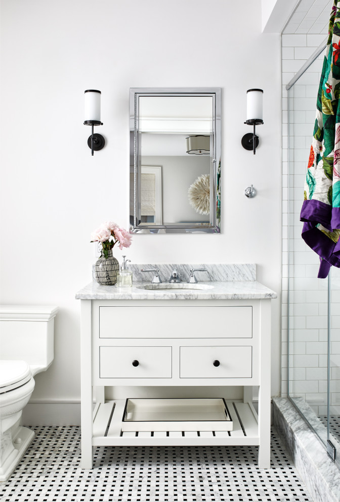 Inspiration for a mid-sized transitional bathroom in Los Angeles with flat-panel cabinets, white cabinets, an alcove shower, a two-piece toilet, subway tile, white walls, porcelain floors, an undermount sink, marble benchtops, multi-coloured floor, a hinged shower door and grey benchtops.
