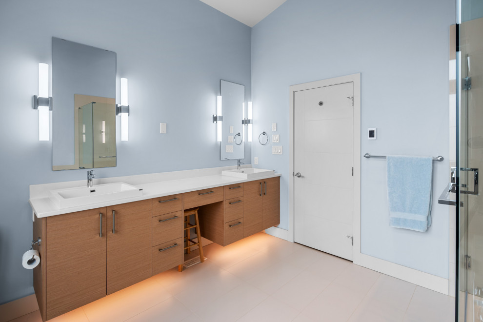 Example of a trendy master blue tile and glass tile porcelain tile, gray floor and double-sink bathroom design in Vancouver with flat-panel cabinets, brown cabinets, a two-piece toilet, blue walls, an undermount sink, quartz countertops, a hinged shower door, white countertops and a floating vanity