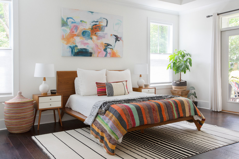 Beach style bedroom in Charleston with white walls, dark hardwood floors and brown floor.