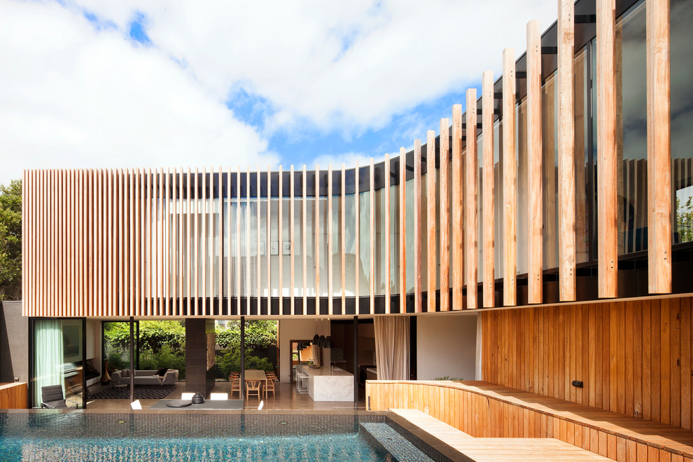 This is an example of an expansive contemporary two-storey brown exterior in Melbourne with wood siding and a flat roof.