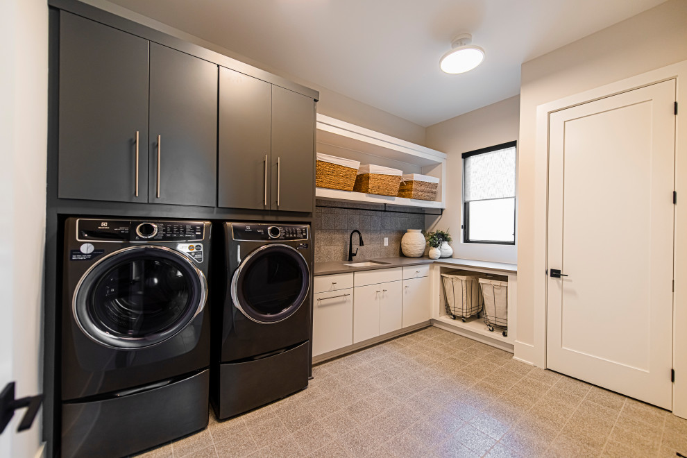 Design ideas for a mid-sized scandinavian l-shaped laundry cupboard in Indianapolis with an undermount sink, flat-panel cabinets, white cabinets and a stacked washer and dryer.