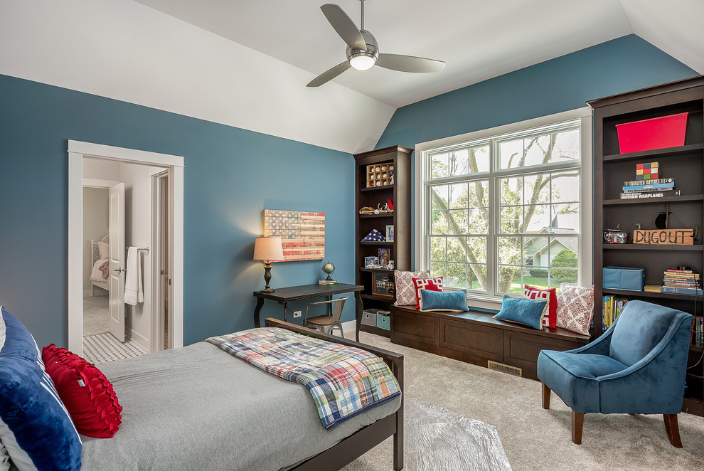 This is an example of a traditional kids' room for boys in Chicago with blue walls, carpet and beige floor.