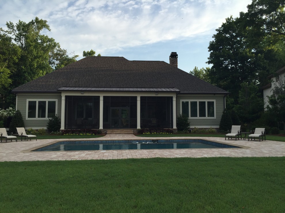 Photo of a mid-sized transitional backyard rectangular lap pool in Atlanta with brick pavers.