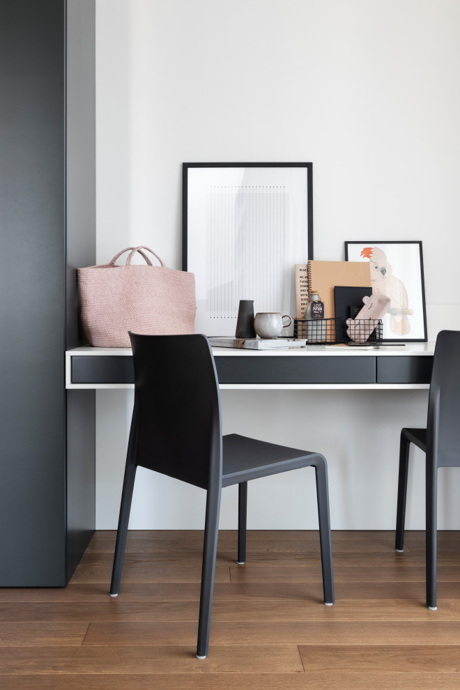 Home studio - large contemporary freestanding desk dark wood floor home studio idea in Milan