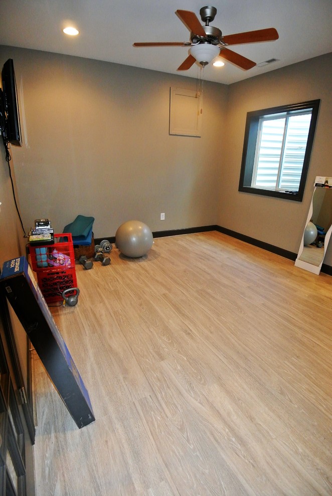 Mid-sized transitional home weight room in Indianapolis with beige walls and light hardwood floors.
