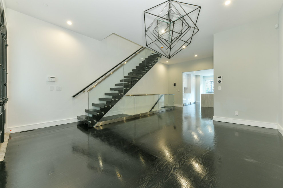 Mid-sized industrial straight staircase in Boston with open risers and glass railing.