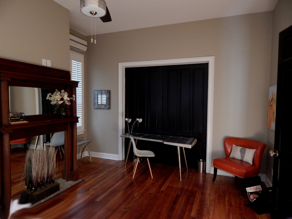 Photo of a large transitional guest bedroom in Other with grey walls, medium hardwood floors and a standard fireplace.