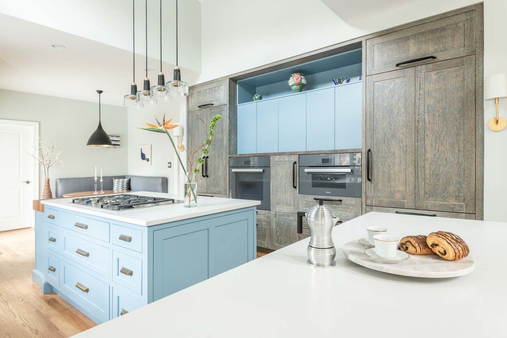 Photo of a large eclectic u-shaped eat-in kitchen in DC Metro with an undermount sink, beaded inset cabinets, white cabinets, wood benchtops, blue splashback, mosaic tile splashback, coloured appliances, light hardwood floors, with island, brown floor and white benchtop.