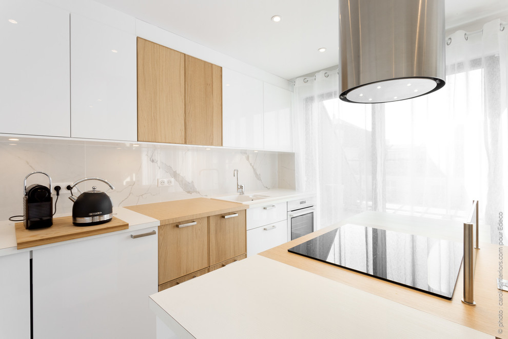 Design ideas for a mid-sized contemporary galley eat-in kitchen in Paris with an undermount sink, beaded inset cabinets, white cabinets, laminate benchtops, white splashback, marble splashback, white appliances, ceramic floors, with island, grey floor and brown benchtop.