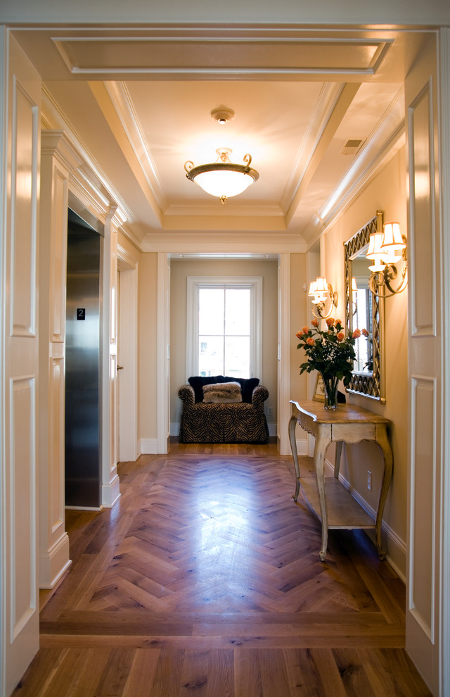 Inspiration for a mid-sized contemporary entry hall in Cincinnati with yellow walls and dark hardwood floors.