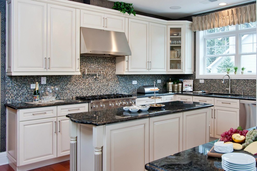 Eat-in kitchen - large transitional l-shaped dark wood floor eat-in kitchen idea in Chicago with an undermount sink, raised-panel cabinets, white cabinets, granite countertops, multicolored backsplash, mosaic tile backsplash, stainless steel appliances and two islands
