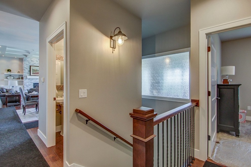 Example of a large transitional medium tone wood floor hallway design with gray walls
