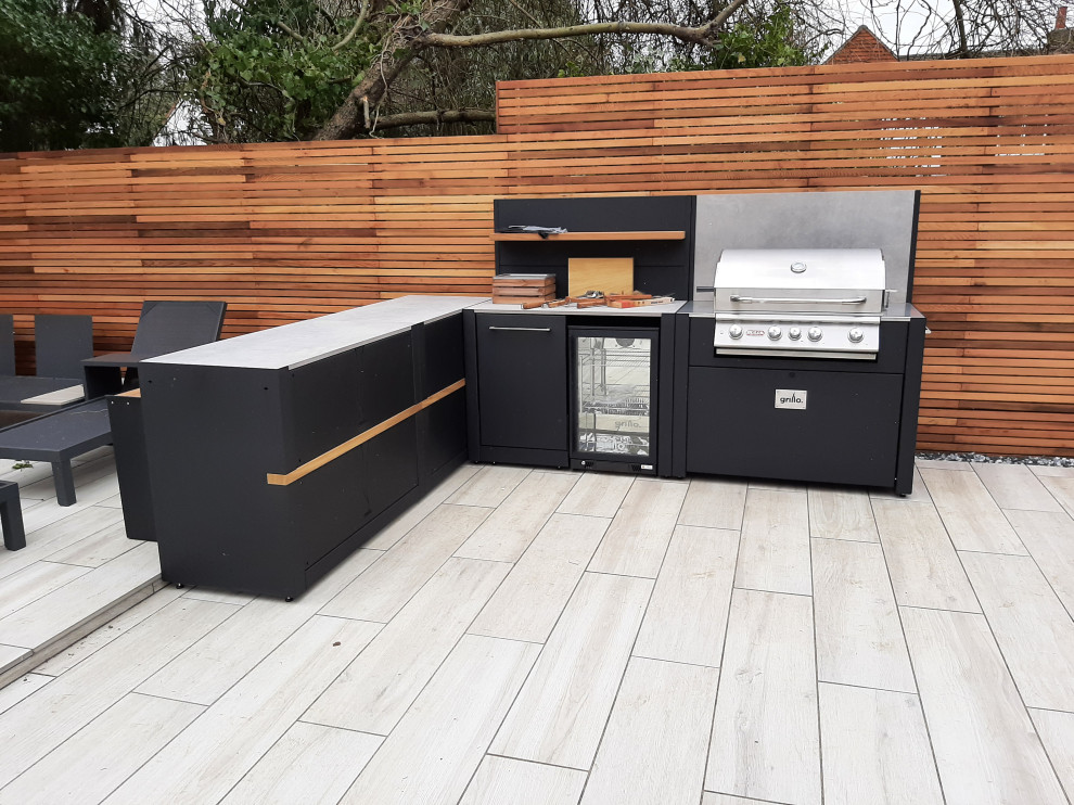 This is an example of a small modern backyard patio in Berkshire with an outdoor kitchen, decking and no cover.