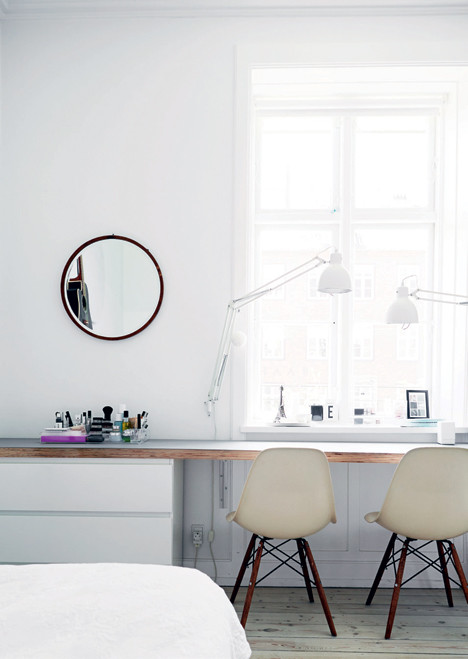 Scandinavian study room in Copenhagen with white walls, light hardwood floors, no fireplace and a built-in desk.