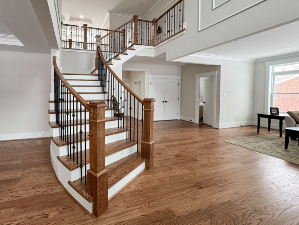 Photo of a medium sized traditional wood curved mixed railing staircase in DC Metro with wood risers.