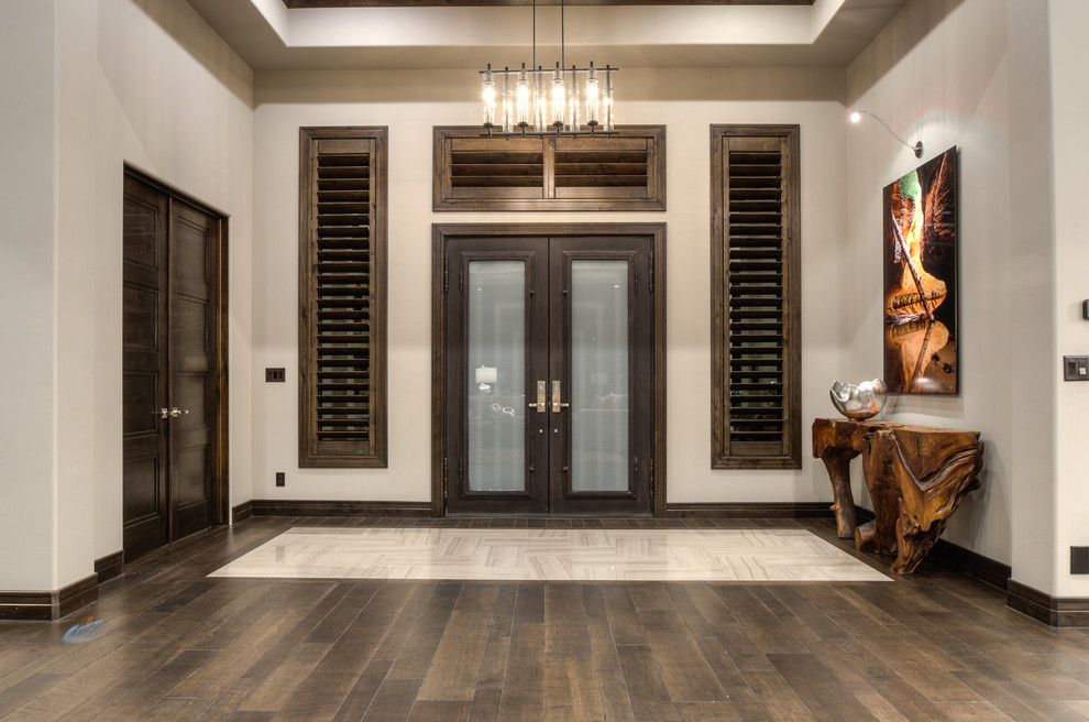 This is an example of a large contemporary entryway in Salt Lake City with grey walls and dark hardwood floors.