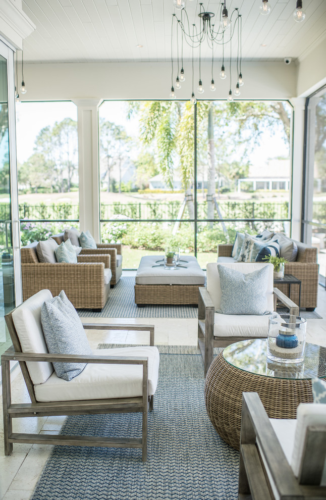 Inspiration for a large transitional stone screened-in back porch remodel in Orlando with a roof extension