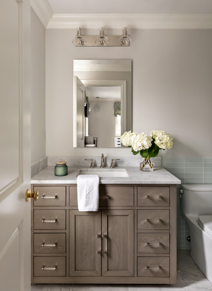 Design ideas for a transitional 3/4 bathroom in New York with shaker cabinets, medium wood cabinets, blue tile, glass tile, grey walls, an undermount sink, grey floor, grey benchtops, a single vanity and a built-in vanity.