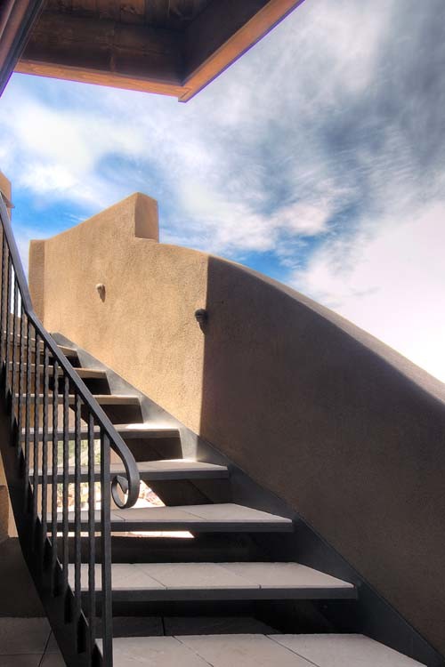 Inspiration for a concrete curved staircase in Albuquerque with open risers.