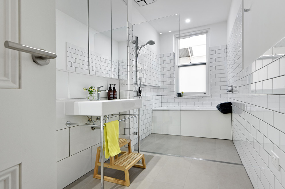 Design ideas for a mid-sized transitional kids bathroom in Adelaide with white tile, a drop-in tub, a console sink, an open shower, subway tile, white walls, ceramic floors and an open shower.