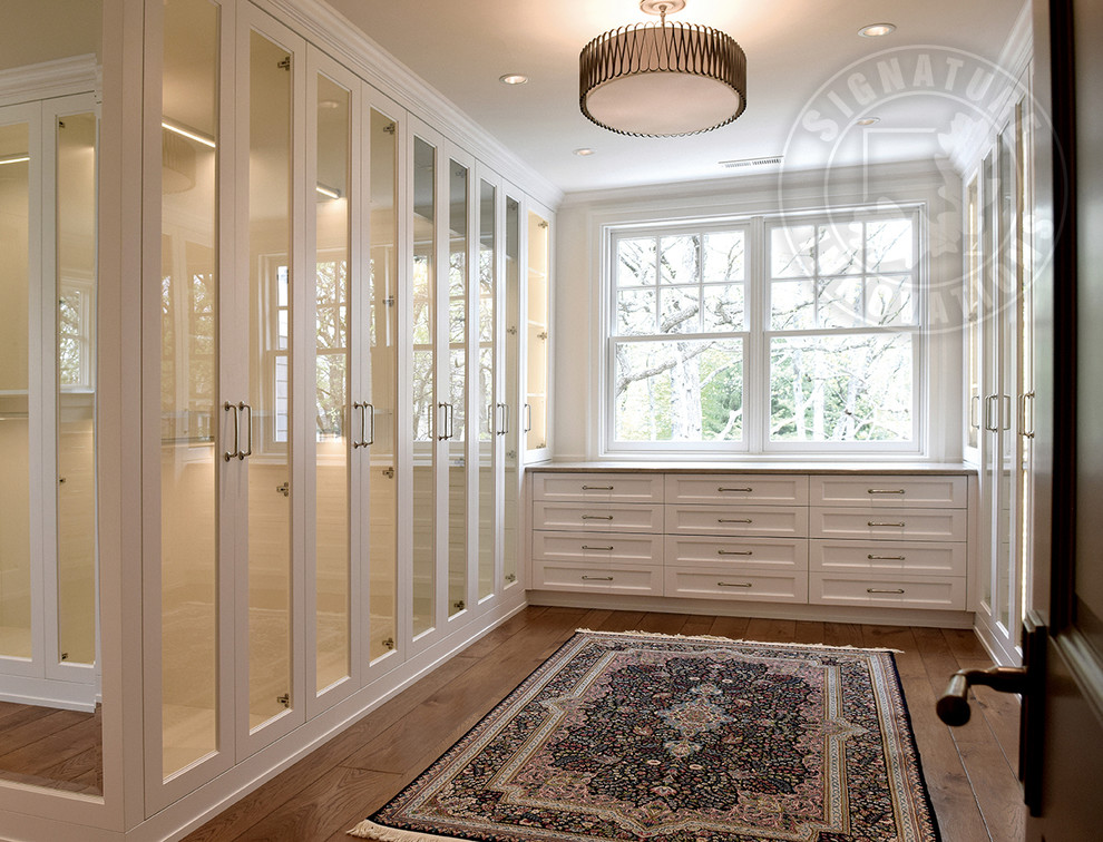 Photo of a large transitional l-shaped eat-in kitchen in Chicago with recessed-panel cabinets, white cabinets, granite benchtops, medium hardwood floors, with island, brown floor and multi-coloured benchtop.