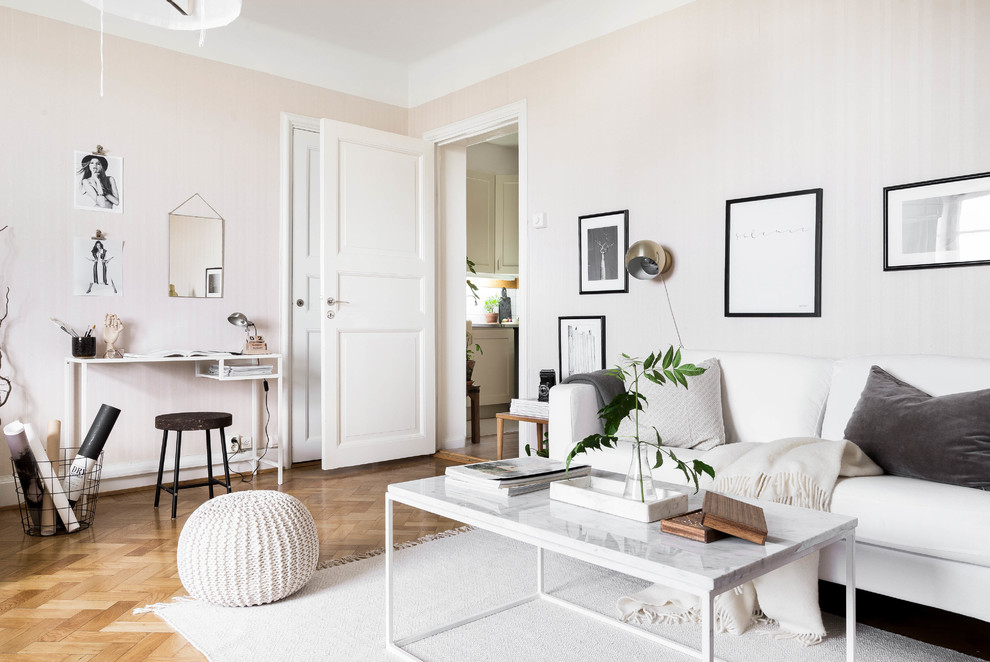 Design ideas for a mid-sized scandinavian formal open concept living room in Stockholm with pink walls and medium hardwood floors.