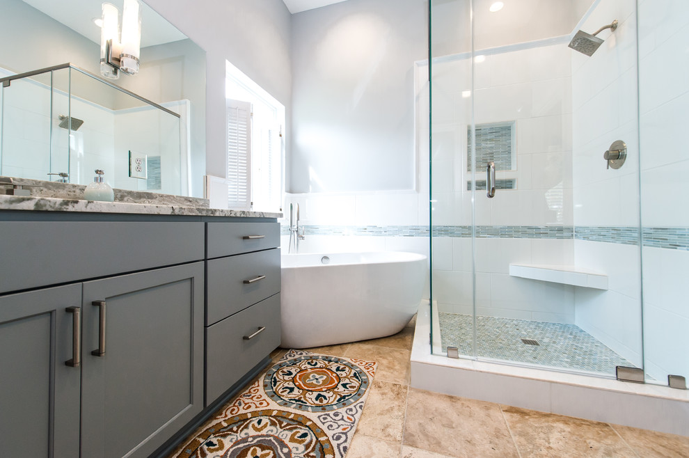 Transitional master bathroom in Charleston with shaker cabinets, grey cabinets, a freestanding tub, a corner shower, white tile, subway tile, an undermount sink, granite benchtops and grey walls.