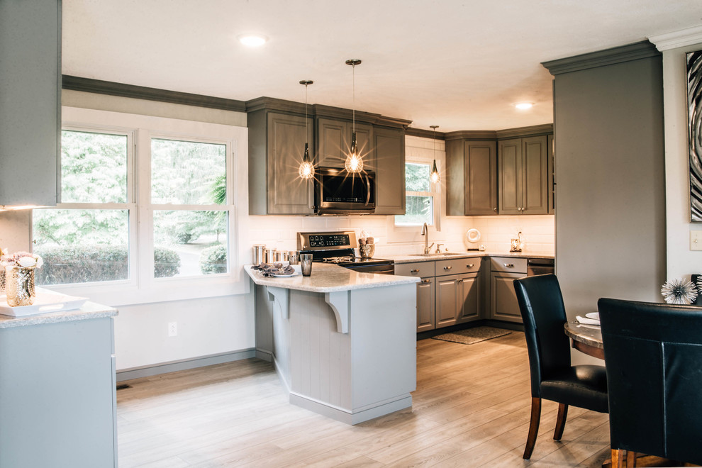 Inspiration for a mid-sized transitional u-shaped medium tone wood floor and brown floor eat-in kitchen remodel with a double-bowl sink, raised-panel cabinets, gray cabinets, granite countertops, white backsplash, ceramic backsplash, stainless steel appliances, a peninsula and gray countertops