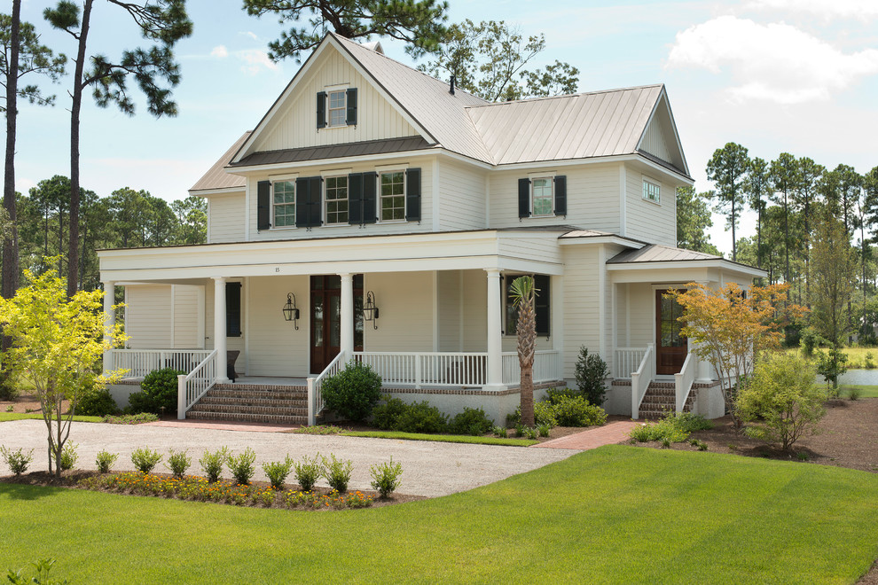 Mid-sized traditional two-storey beige house exterior in Charleston with wood siding and a metal roof.