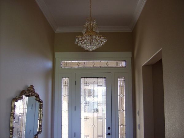 Example of a mid-sized foyer design with beige walls and a glass front door