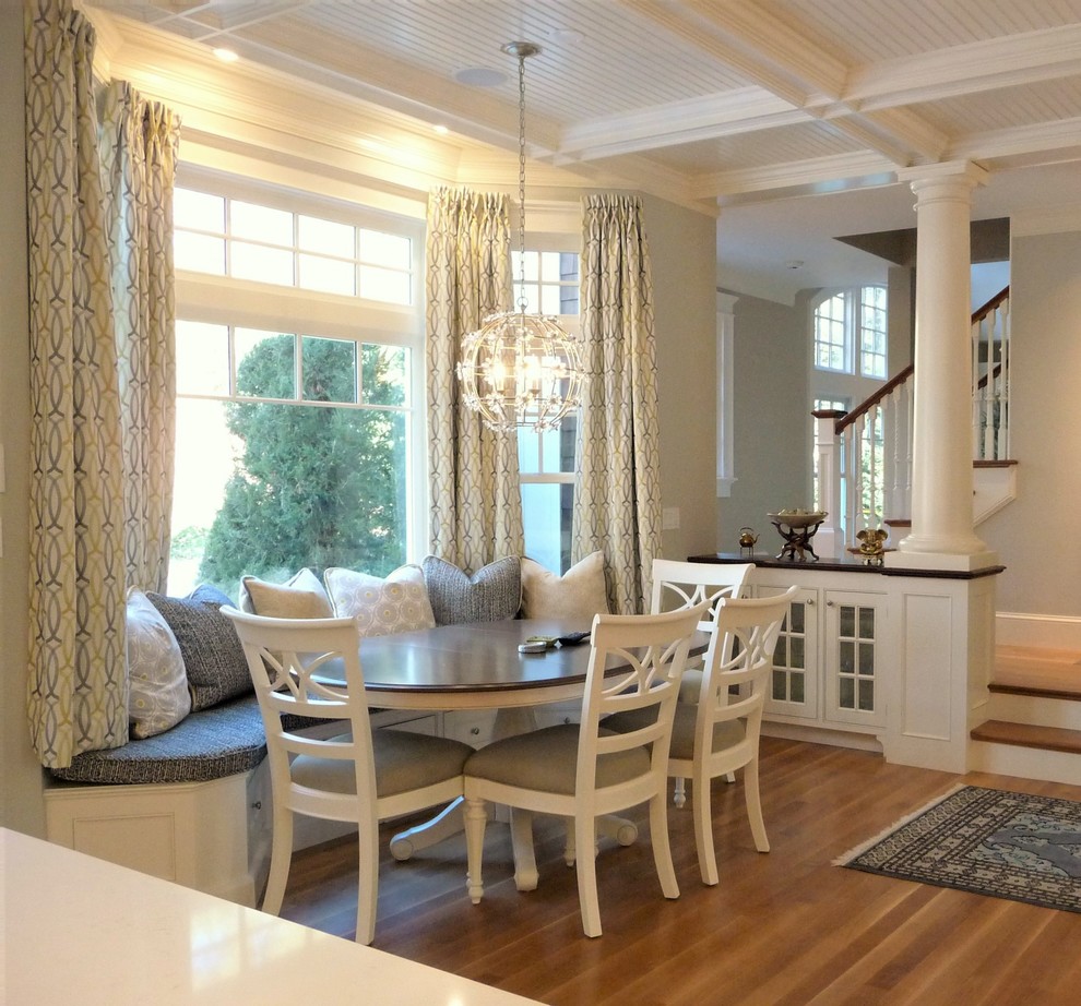 Inspiration for a large transitional u-shaped medium tone wood floor kitchen/dining room combo remodel in Boston with an undermount sink, beaded inset cabinets, white cabinets, quartzite countertops, white backsplash, ceramic backsplash, stainless steel appliances and an island