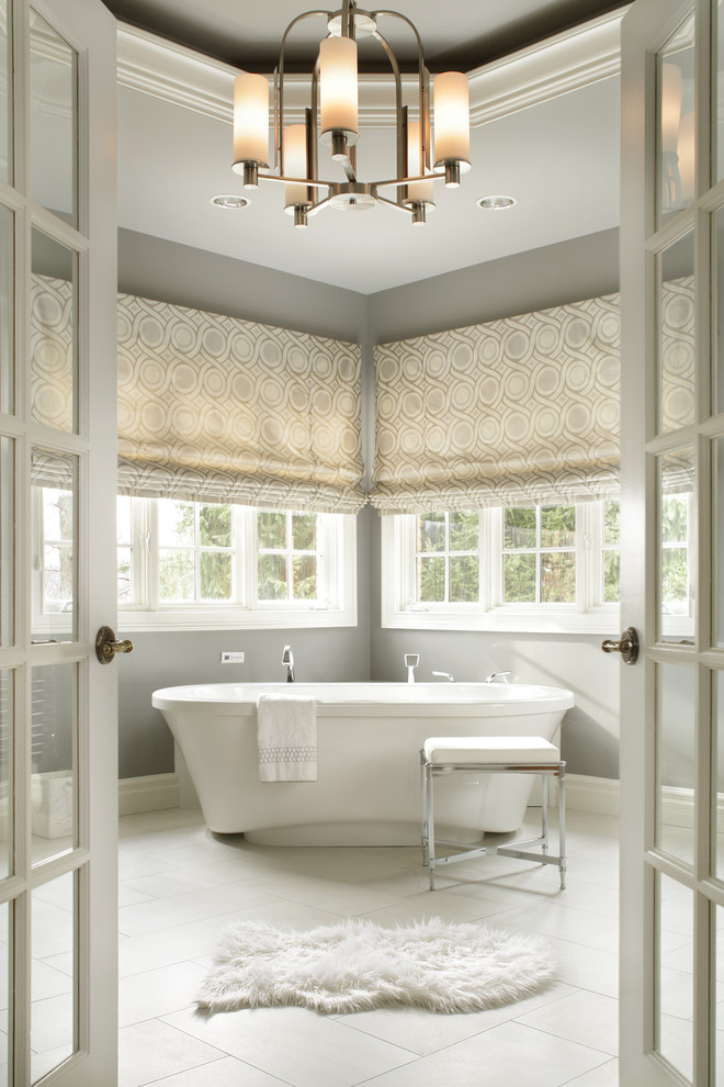 Design ideas for a large traditional master bathroom in New York with a freestanding tub, grey walls, porcelain floors, grey cabinets, a one-piece toilet, gray tile, porcelain tile, an undermount sink and engineered quartz benchtops.