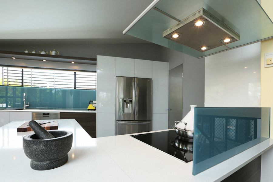 This is an example of a mid-sized modern l-shaped eat-in kitchen in Brisbane with flat-panel cabinets, white cabinets, blue splashback, white floor, glass sheet splashback, a double-bowl sink, quartz benchtops, ceramic floors, a peninsula and stainless steel appliances.