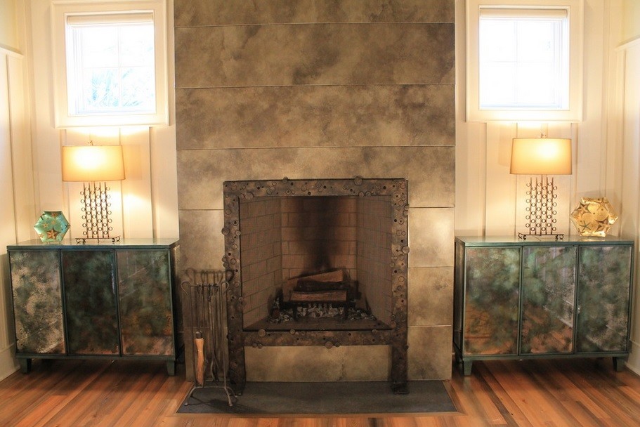 Photo of a transitional living room in Charleston with a standard fireplace and a metal fireplace surround.