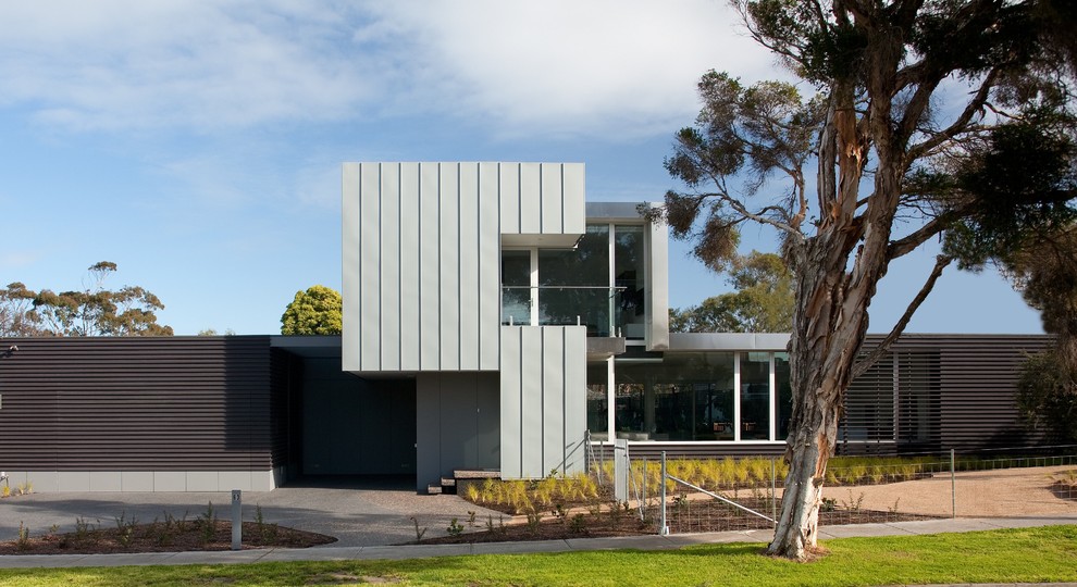 Inspiration for a contemporary two-storey exterior in Melbourne with a flat roof.