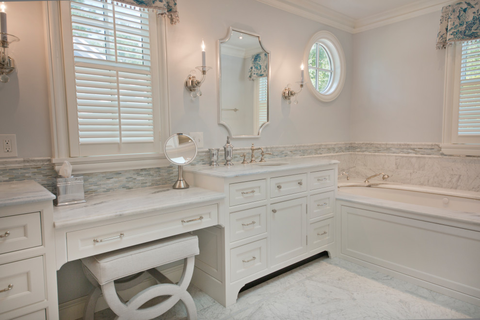 This is an example of a large traditional master bathroom with a built-in vanity.