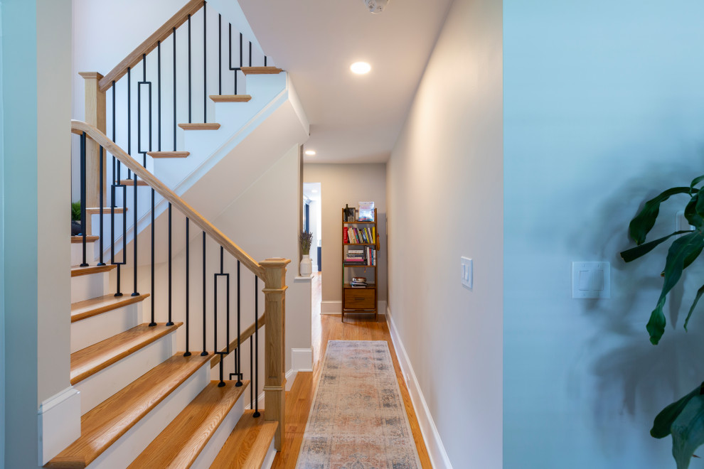 Inspiration for a mid-sized transitional wood straight staircase in New York with wood risers and wood railing.