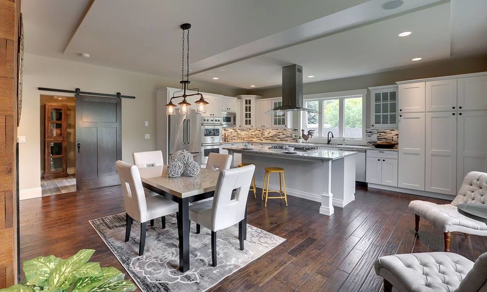Mid-sized transitional single-wall dark wood floor and brown floor eat-in kitchen photo in Minneapolis with shaker cabinets, white cabinets, multicolored backsplash, matchstick tile backsplash, stainless steel appliances and an island