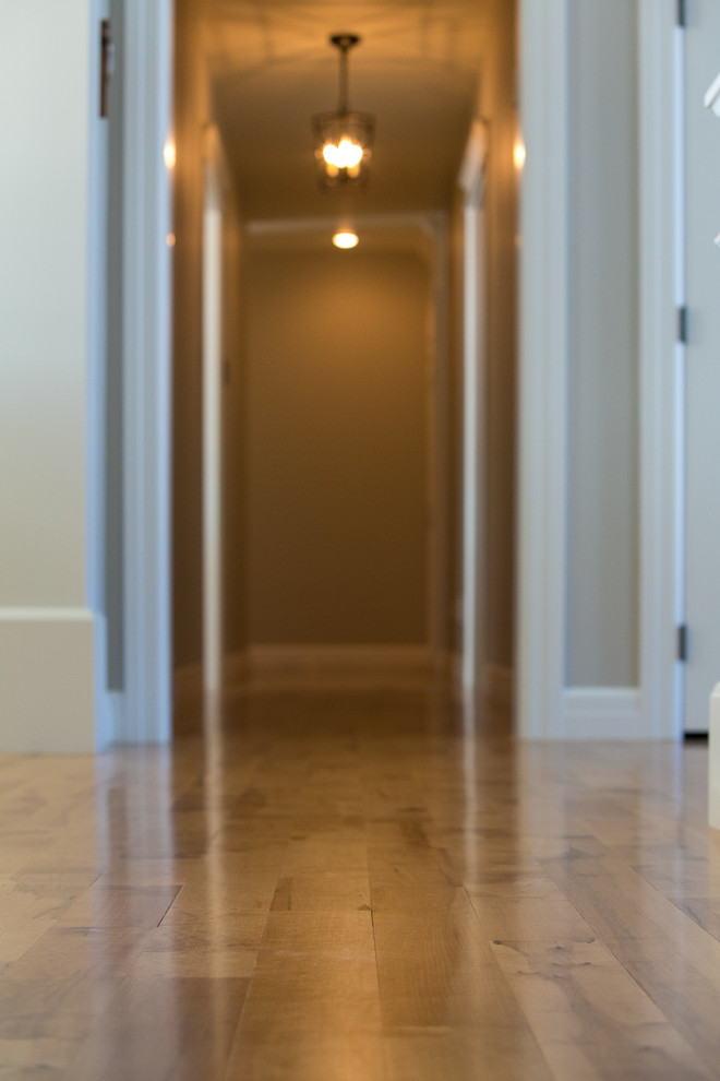 Inspiration for a mid-sized transitional medium tone wood floor and brown floor hallway remodel with beige walls