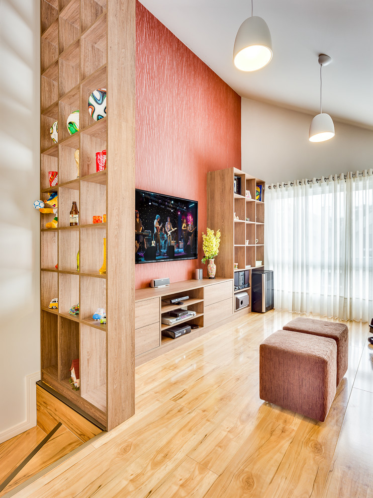 Mid-sized contemporary enclosed home theatre in Other with orange walls, plywood floors and a wall-mounted tv.