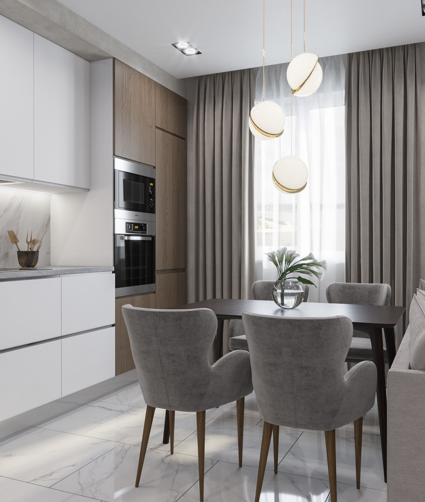 Photo of a mid-sized contemporary single-wall open plan kitchen in Other with a drop-in sink, flat-panel cabinets, white cabinets, solid surface benchtops, white splashback, stainless steel appliances, white floor, grey benchtop, porcelain splashback and ceramic floors.
