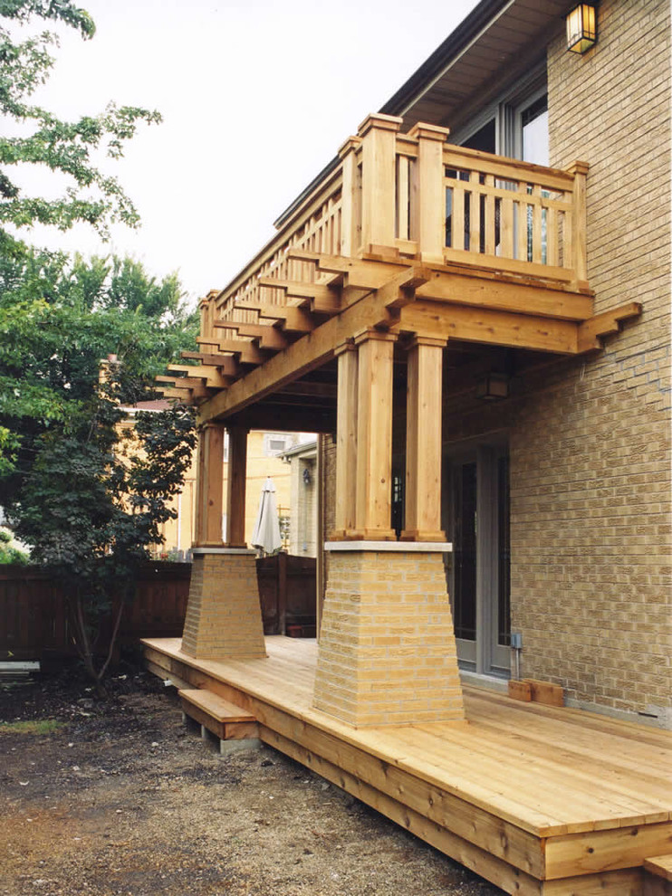 Mid-sized arts and crafts balcony in Chicago with no cover and wood railing.