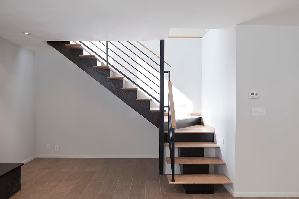Mid-sized modern wood l-shaped staircase in Portland with painted wood risers.