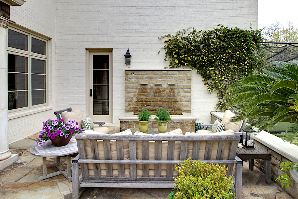 Photo of a mediterranean patio in Dallas with a water feature.