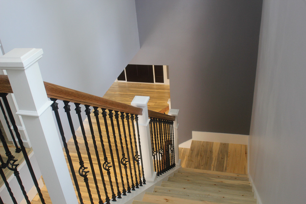 Photo of a mid-sized arts and crafts wood l-shaped staircase in Denver with painted wood risers.